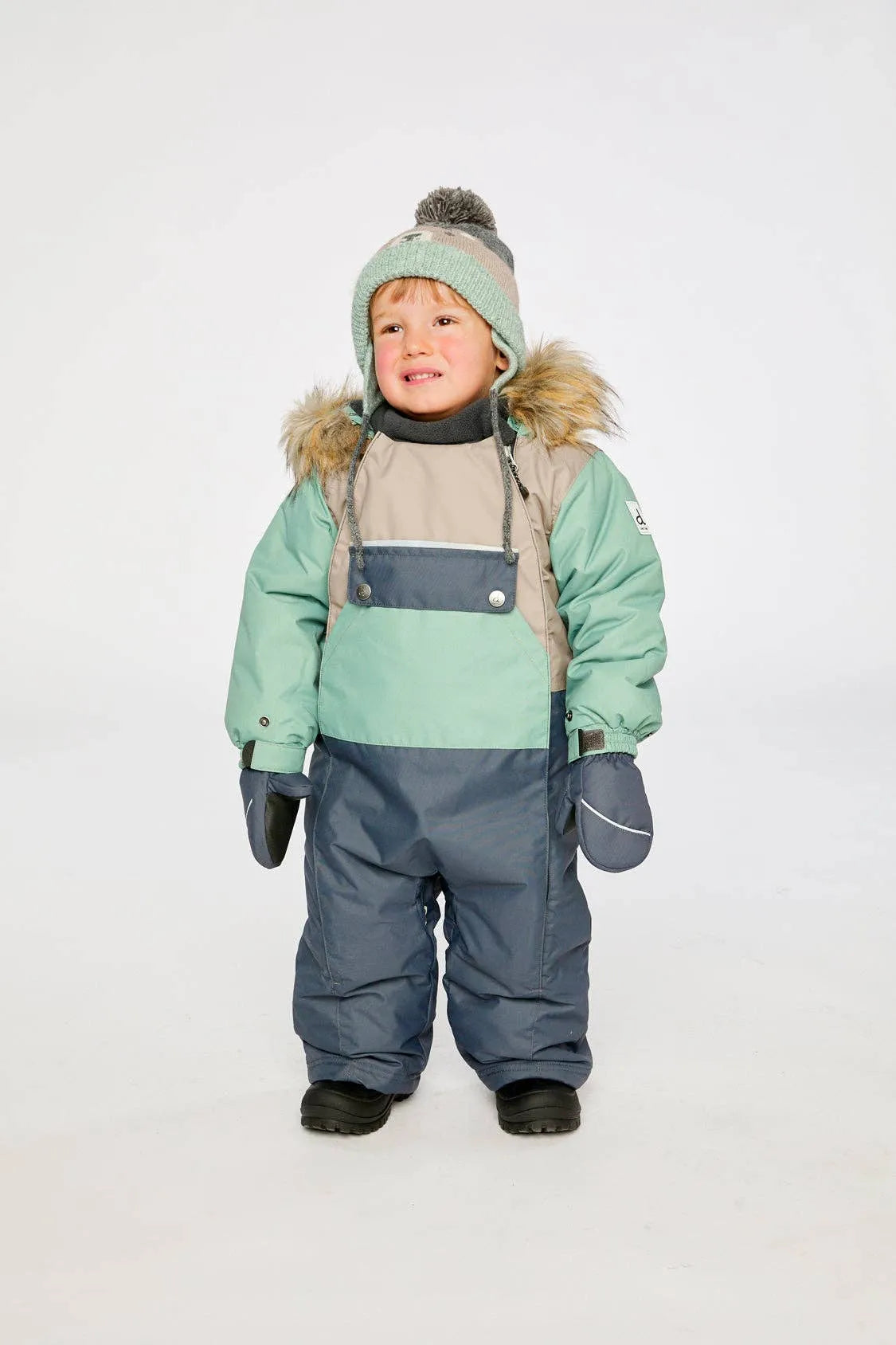 Child wearing the Cool Dark Grey, mint and taupe one-piece snowsuit, front view