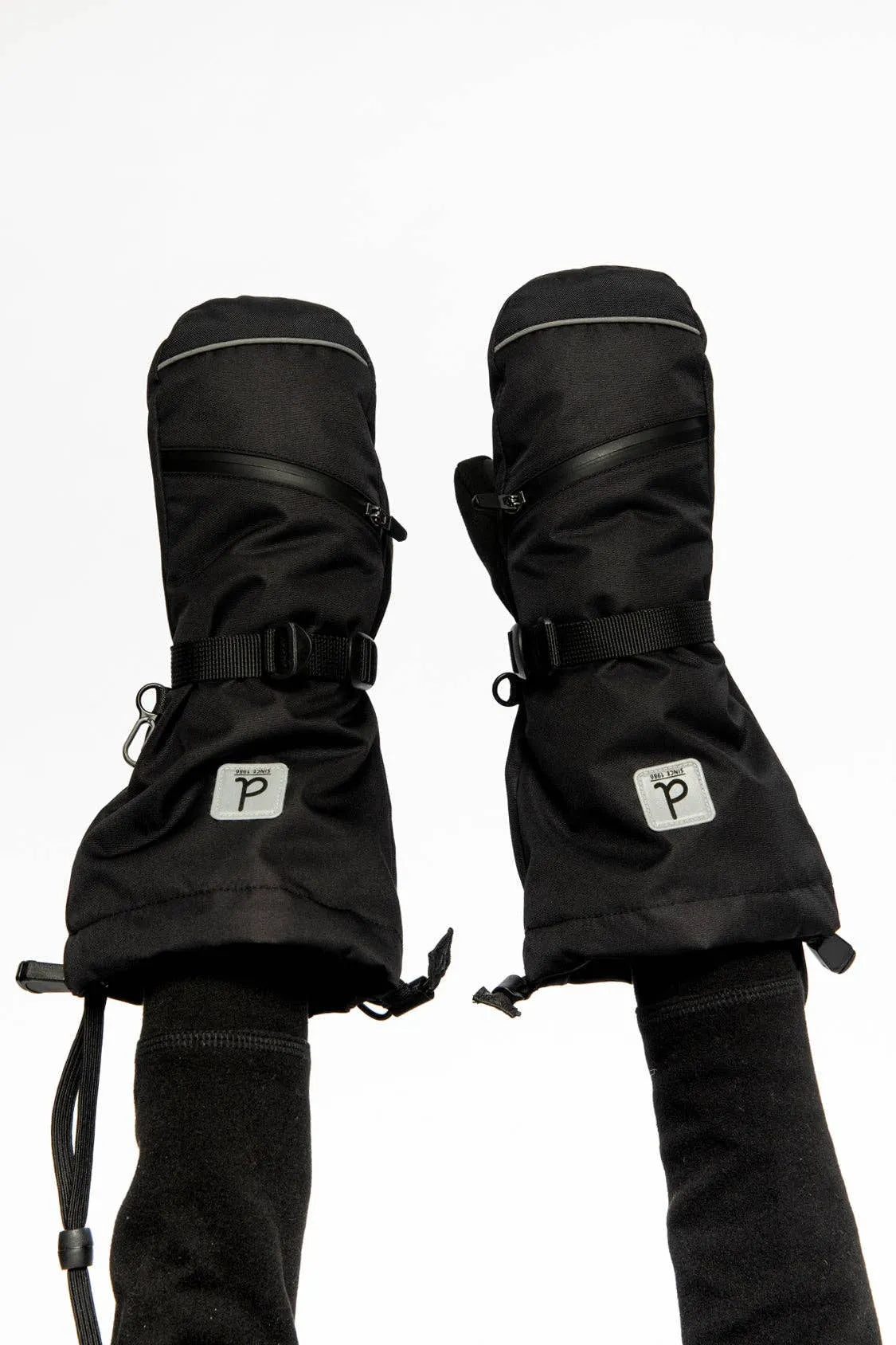 Both mittens worn with the long cuffs pulled over fleece sleeves, showing the zip pocket, wrist strap and reflective trim