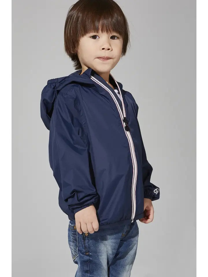 Child wearing the O8 navy packable rain jacket, angled front view