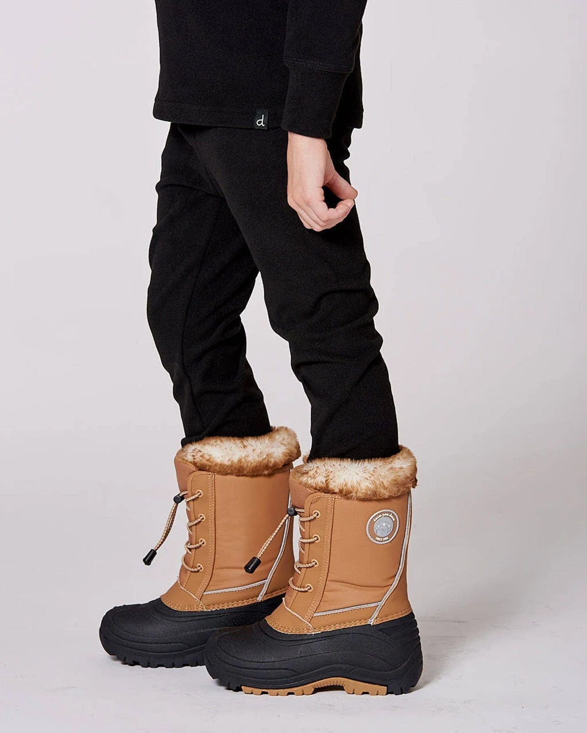 Child wearing the Brown Sugar winter boots, side and rear view