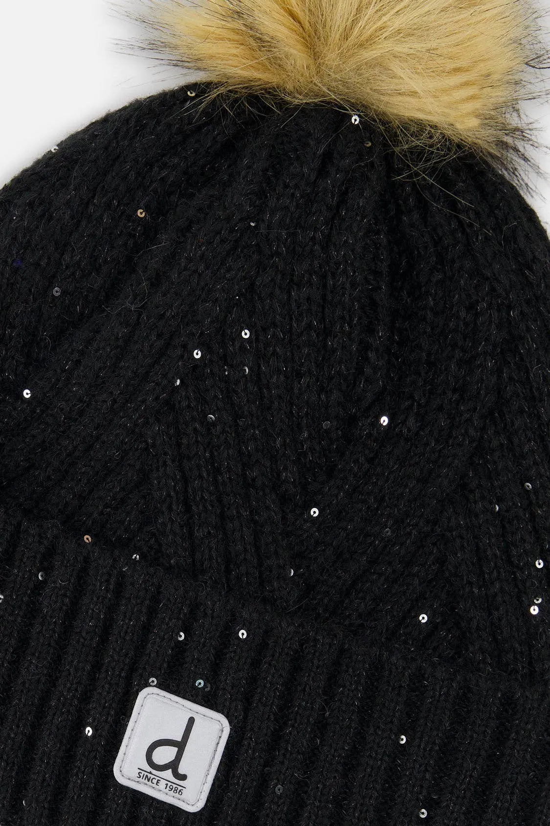 Close view of the Black chevron knit, sparkles, faux-fur pompom and Deux par Deux logo