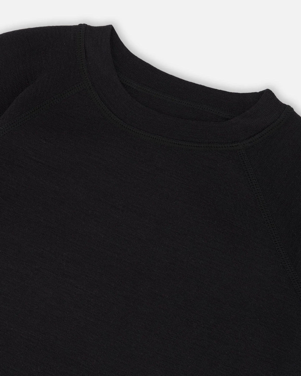 Close view of the Black base layer fabric and neckline stitching