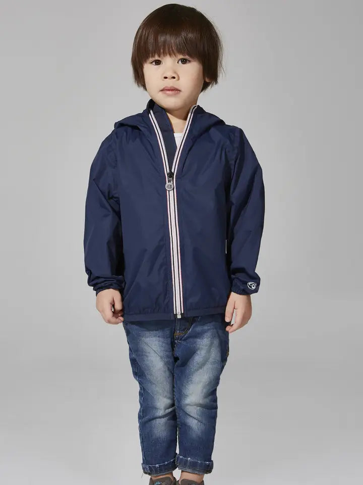 Child wearing the O8 navy packable rain jacket, front view